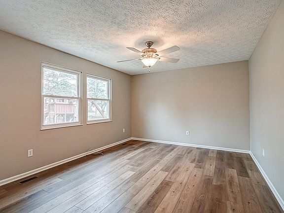 Living Room off kitchen w/ new luxury, vinyl flooring (also throughout the rest of the first and second floors of home).