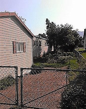 RV parking spot and backyard beyond