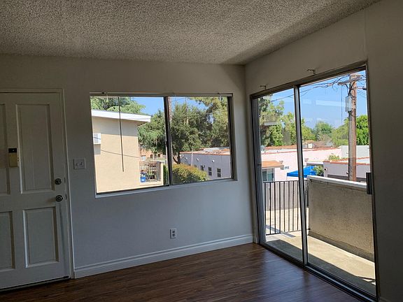 Living room has sliding door/balcony and a window
Vertical blinds are included