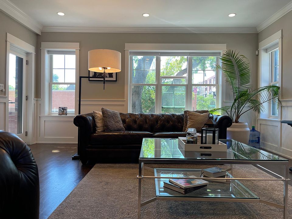 Bright sun-drenched living room with windows on three sides