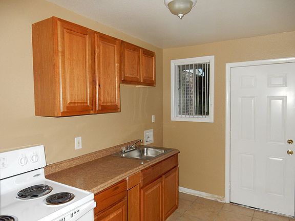 Kitchen with new cabinets, refrigerator and range.