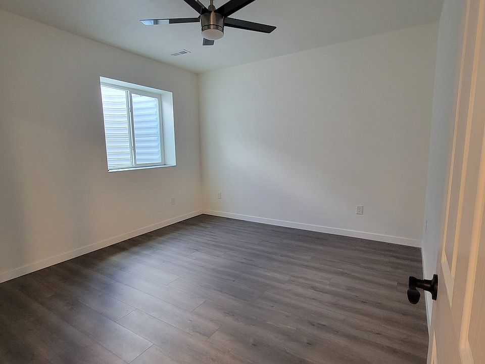 Private bedroom with a large window and high ceilings.
