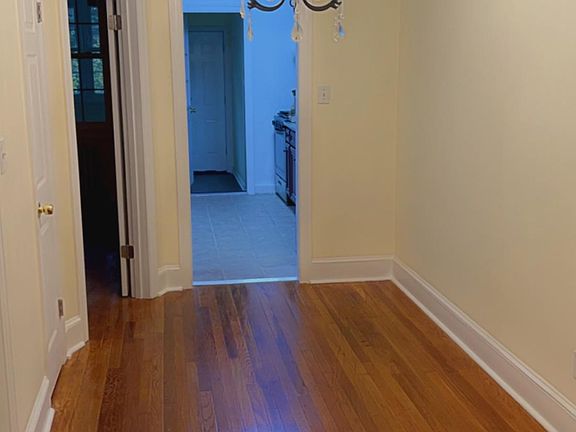 Spacious dining room area with closet space and classic lighting