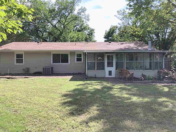 Back of home with shed to relax