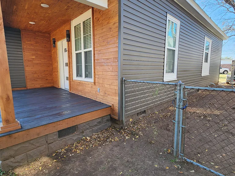 Right side of home with fenced in backyard