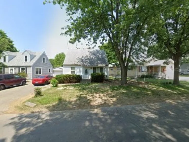 Front of the house with side of the house parking.