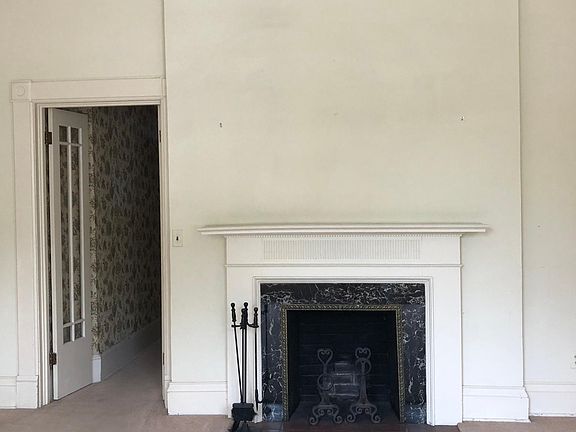 Living room, facing east. Hallway (on left) that leads to dining area and scenic view of the lake.