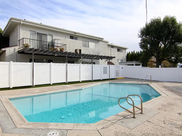 Gated pool with lounging area at Cedar Glen.