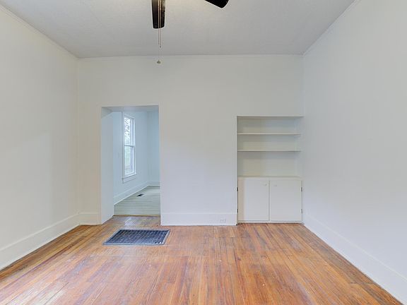 Spacious living room with built-in bookcase adding to the midtown charm everyone loves