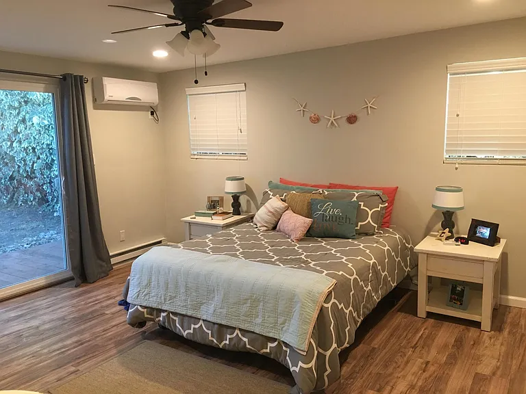 Large primary bedroom with sliding door to the deck and back yard