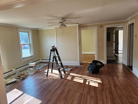 One room going into another living/Dining . We are in the middle of freshly painting this apartment