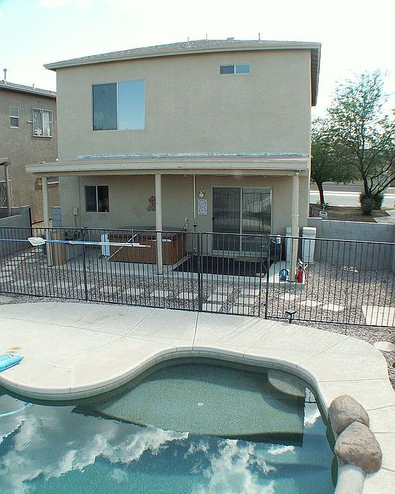 Yard with pool, spa, and large covered patio.