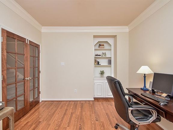The study could also work as a formal living room or a second game room down. The double crown molding adds elegance to the room.  The built in is perfect for storage and displaying books and treasures.