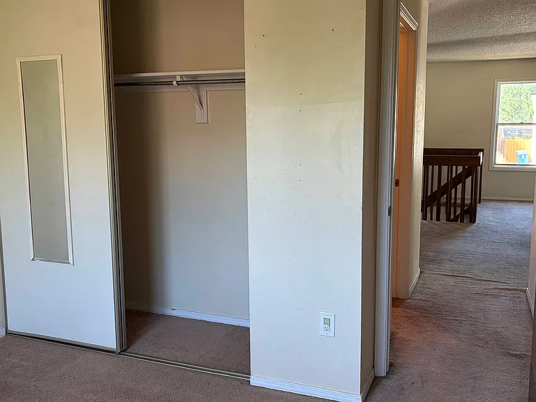 Upstairs Bedroom 2 Closet and view to Hall and Entry