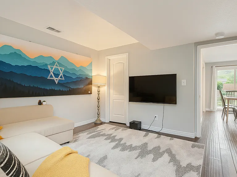 Relax in this comfy bedroom with a stylish sofa bed, perfect for cozy movie nights.