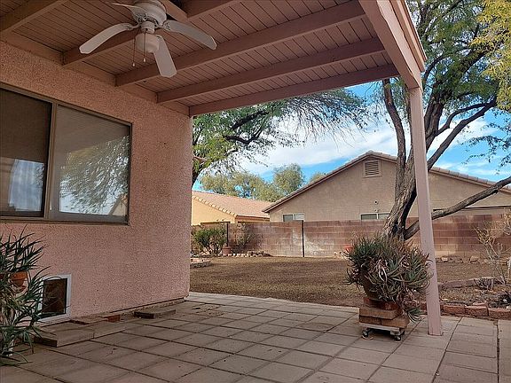 Covered back patio with fan.