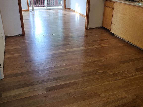 Eat in kitchen, with sun-room extension in back ground, opens onto a small balcony. White oak hardwood floors. They look dark in this photo.