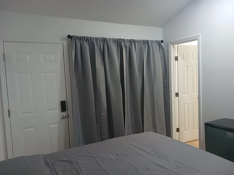 Mini-master bedroom, private bath, with bright can lighting and ceiling fan lighting also.