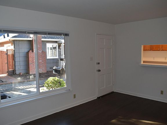 family room view with large window looking into kitchen