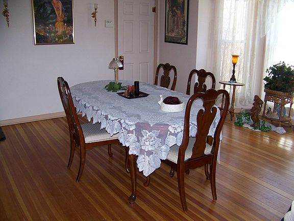 Formal dining room with bay window and hardwood floors