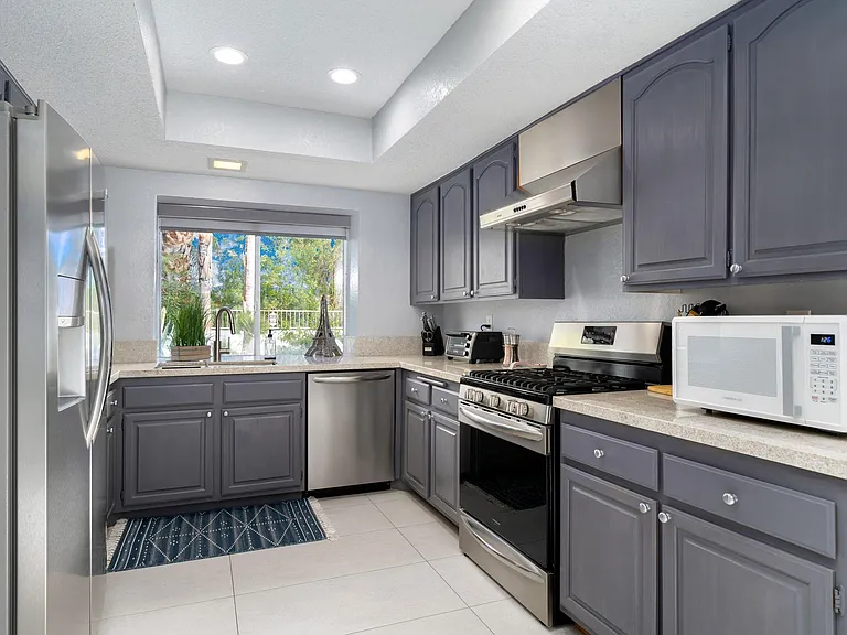 Kitchen with window looking out to backyard.
