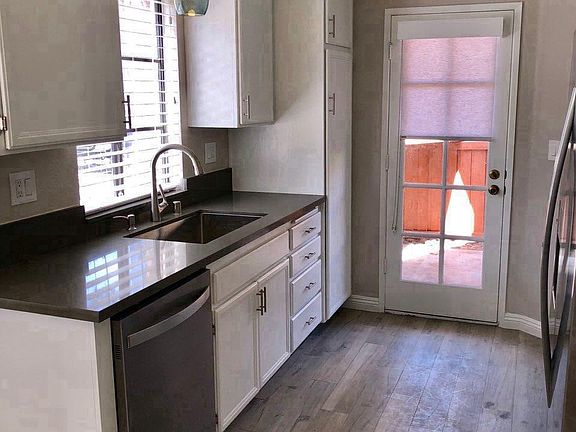 Galley kitchen with outside door to private patio