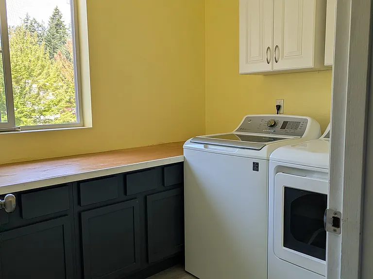 Dedicated 8.5' x 6.5' laundry room with countertop, cabinets, and storage. Washer and Dryer included or can be removed as desired.