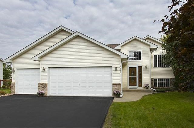 Front Exterior, refinished driveway, generous three car garage, and lots of mature trees!