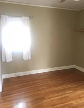 Bedroom with wood floors and ceiling fan