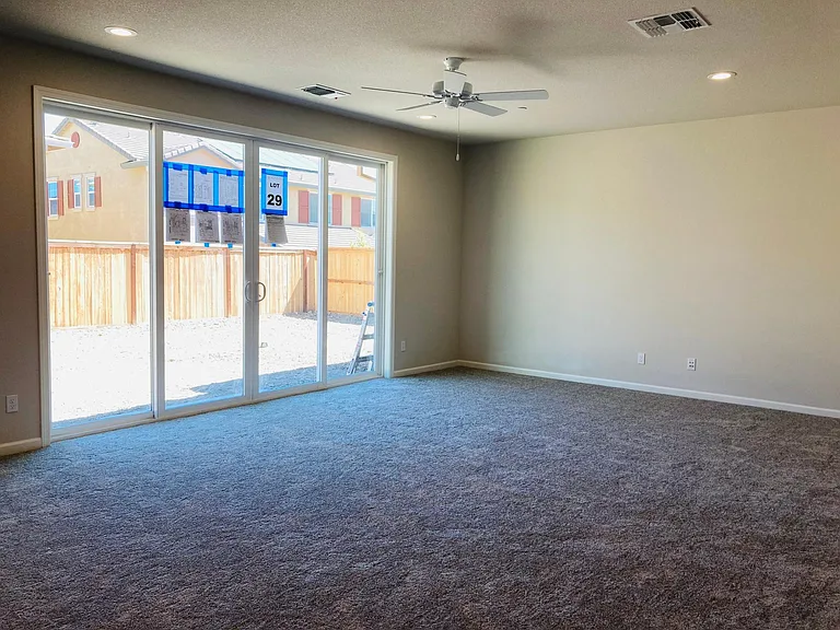 Family room with double glass doors into backyard