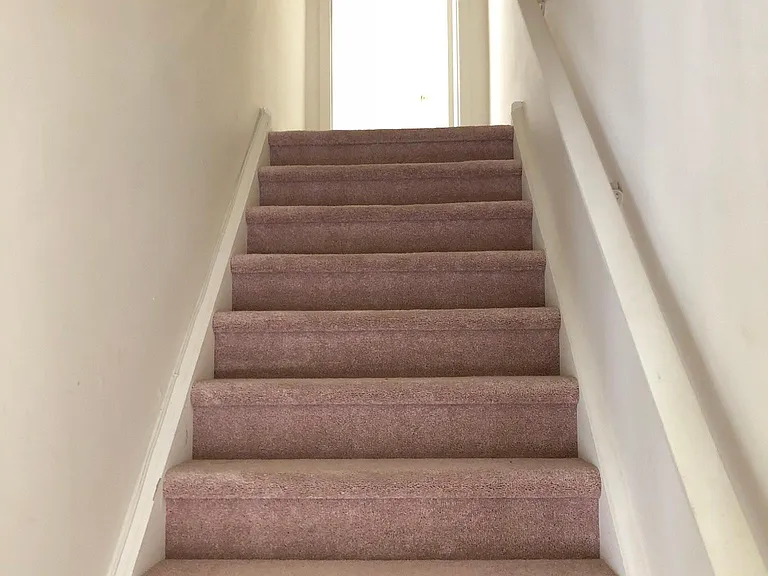 Stairs from 2nd floor leading to 3rd floor.