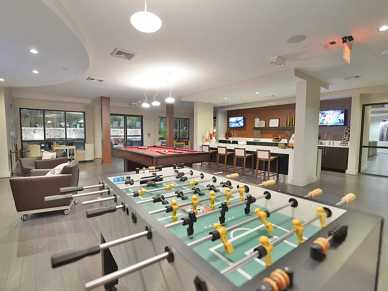 Clubroom featuring foosball and billiards