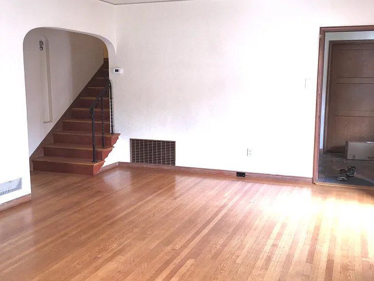 Living room showing stairs to upstairs level