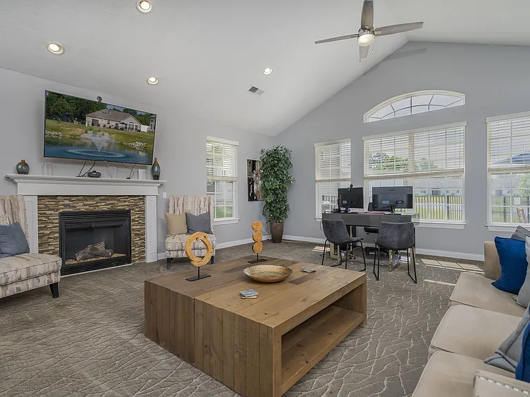 Step into a warm and inviting living space, perfect for relaxing or entertaining with a fireplace and media setup.