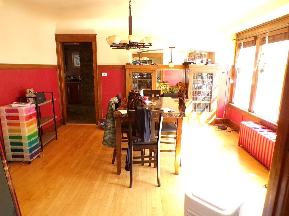 Dining room with nice lighting & sconce over china cabinet with beveled glass doors