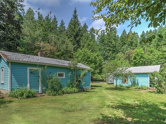 Shop in the foreground and two car garage beyond.