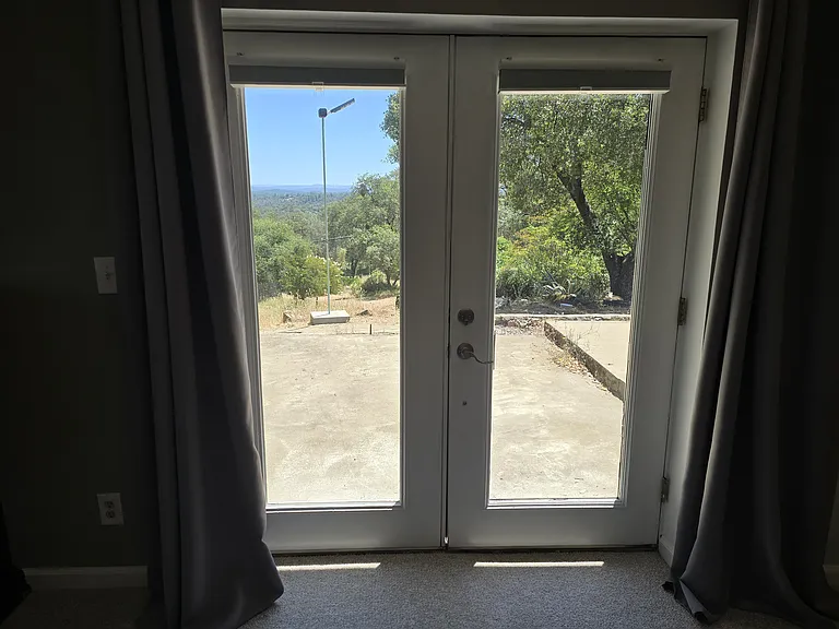 These are your private entrance french doors. They provide a distant view to the mountains. 3/4 in. room-darkening shades provide a barrier against both light, heat/cold. Drapery provides another layer.
