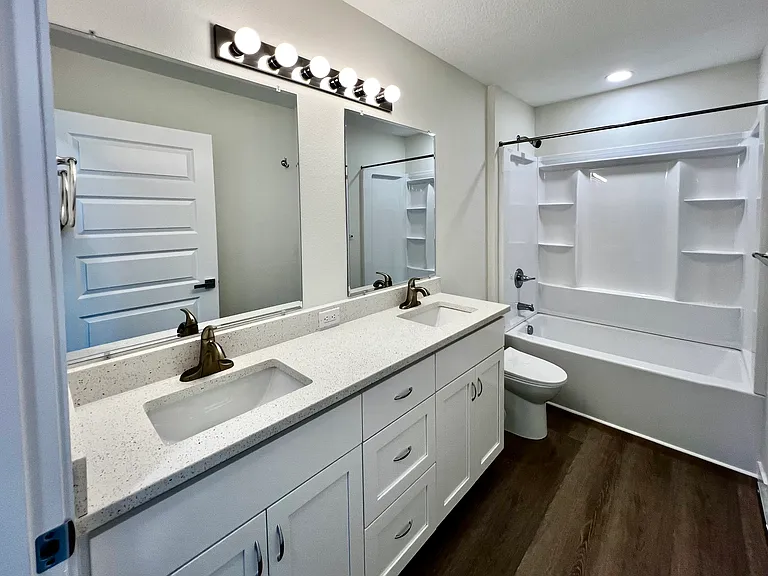 Double sinks and tub / shower bathroom.