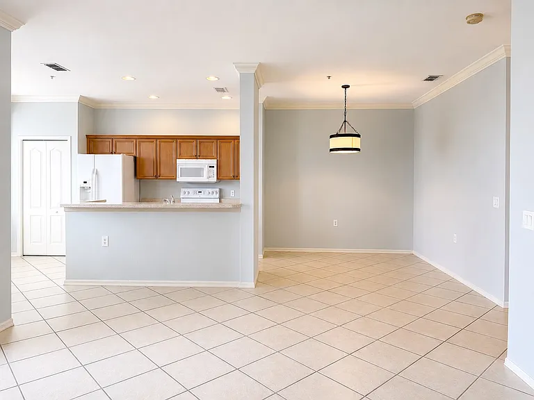 Open-concept living and dining area with breakfast bar and abundant natural light