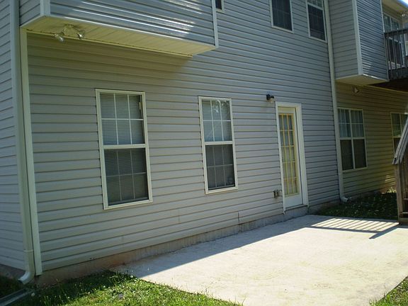 Patio in rear of home next to the deck.