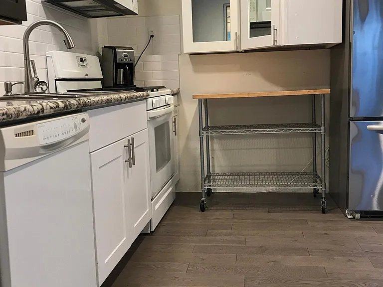 BOTTOM DUPLEX KITCHEN MIRROR CABINETS;GRANITE COUNTERTOPS; GAS STOVE; MOVABLE ISLAND AND OVERSIZED FRIDGE.