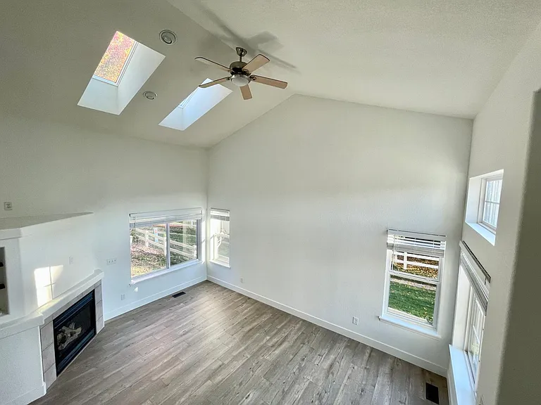 The living room features a gas fireplace and large gathering space