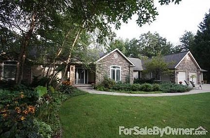 Front
						:
						Stone facade with three car garage and professional landscaping on large lot.