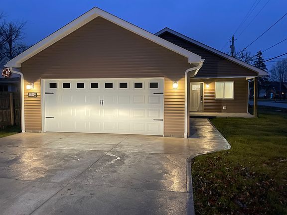 Cement driveway and two car garage.