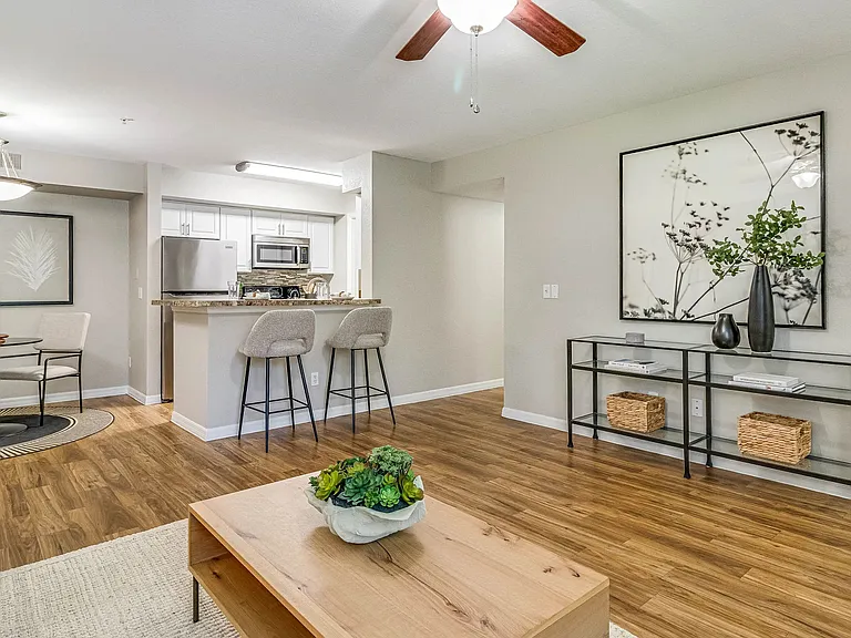 Embrace a spacious, open-concept living exuding timeless elegance with warm wood-like flooring.