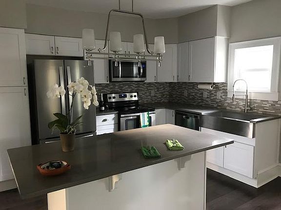 All new SS Whirlpool appliances, quartz countertops/back-splash, pull-down faucet