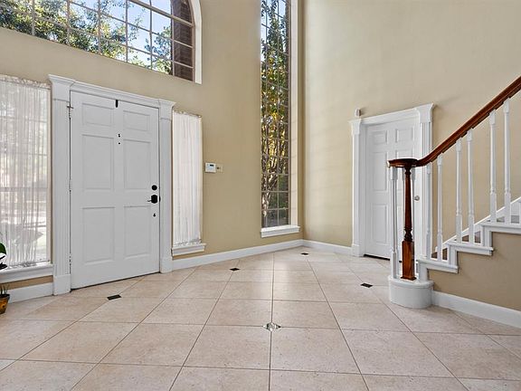 Grand two story foyer welcomes your guests. Neutral porcelain tile with granite inserts add the right amount of elegance.