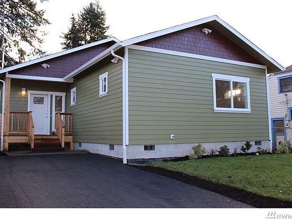 Charming covered porch greets visitors.  Plenty of off street parking with carport with alley access at rear of home.