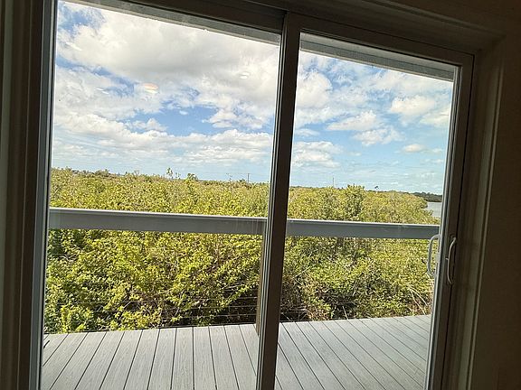 Sliding doors from living room leading to private outdoor deck
