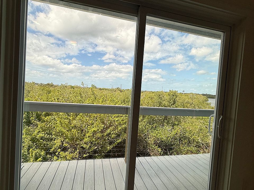 Sliding doors from living room leading to private outdoor deck